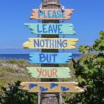 pink teal yellow multi color please leave nothing but your feet road signage